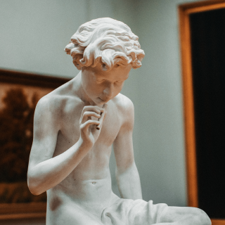 Marble statue of a boy thinking